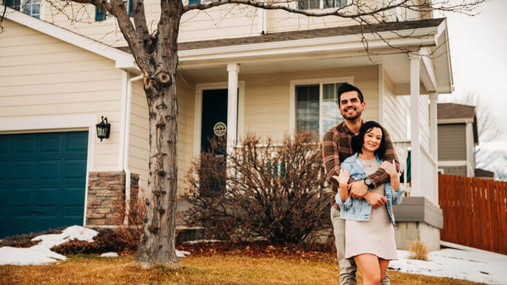 A Couple in front of their house