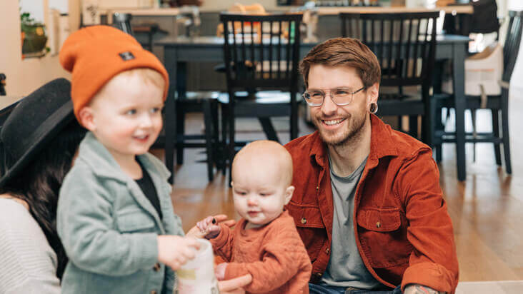 Image of children playing and parents watching