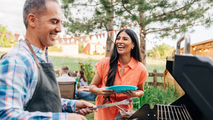 A couple laughing while at a cookout